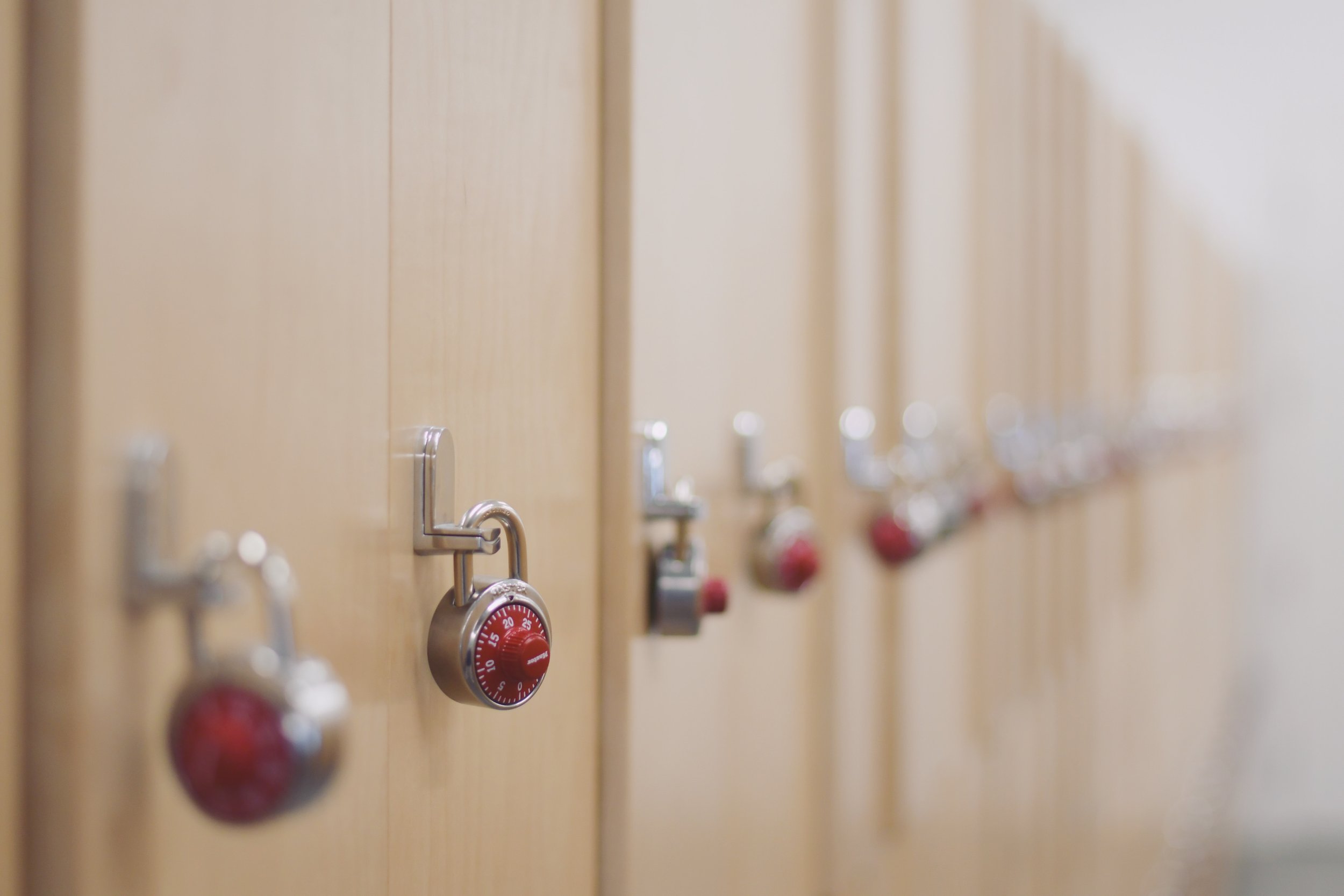 Photo of a row of lockers in a secondary school with padlocks on each
