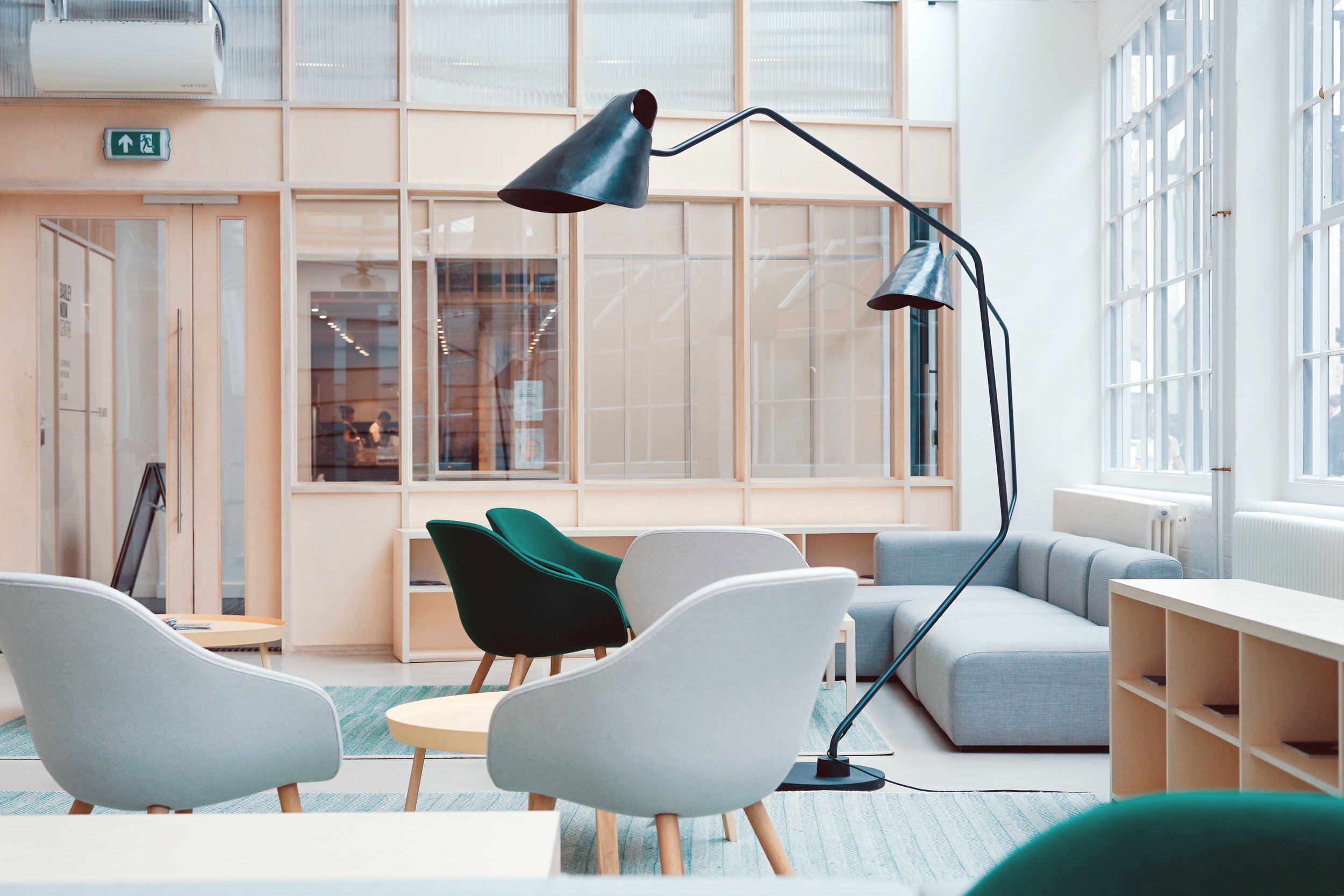 Photo of a hip corporate office lobby with lounge chairs and trendy lamps