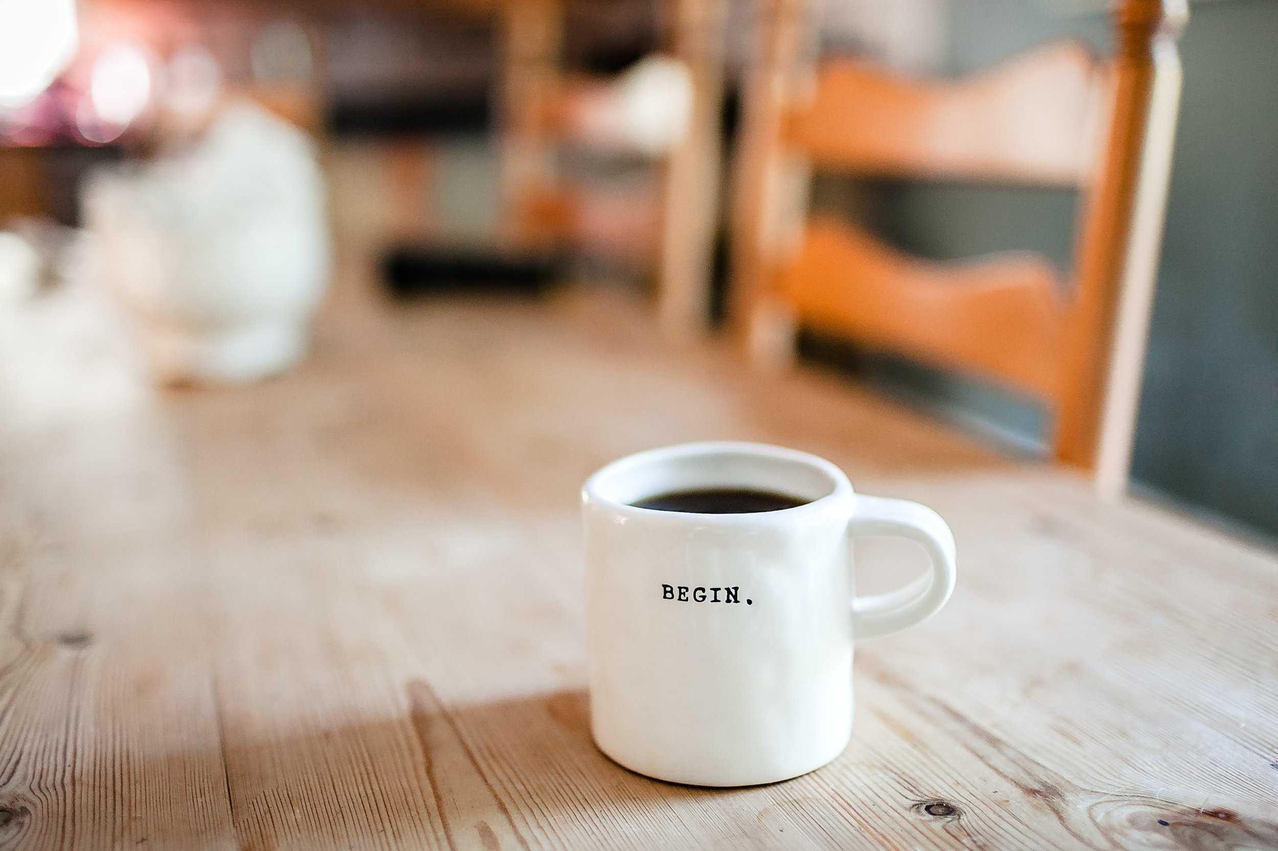 A mug of coffee that says BEGIN