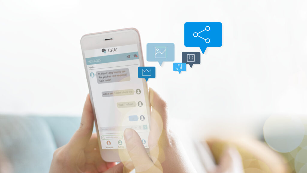 A woman on a blurred couch texts on her phone in a chatting app.