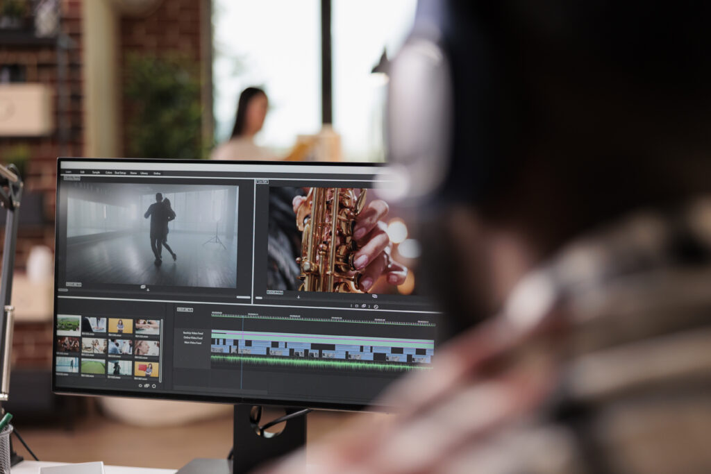 An office worker edits a movie using video software on their computer.